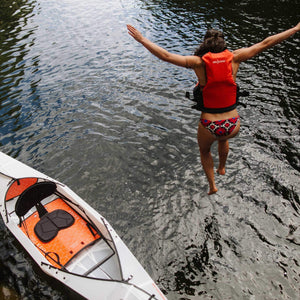 woman jumping into water with Oru Kayak Beach LT