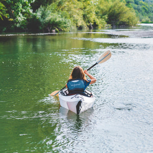 woman paddling Oru Kayak Inlet from behind