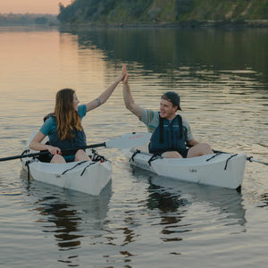 Two happy paddlers in their Oru Kayak Lakes