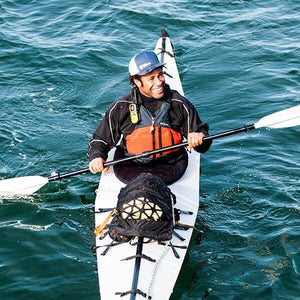 Man kayaking with an Oru Kayak Neoprene Spray Skirt