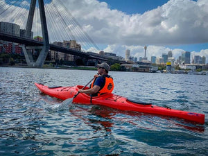 Man paddling a Pakayak Bluefin 142 kayak near ANZAC Bridge Sydney