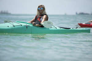 Blonde woman paddling a Pakayak Bluefin 142