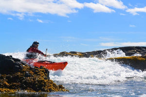 Rocky coastline landing in a Pakayak Bluefin 142 kayak