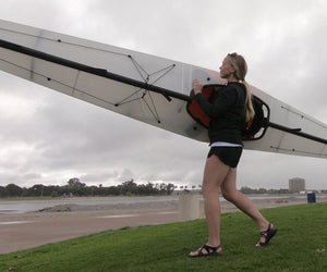 woman carrying an Oru Kayak Coast XT